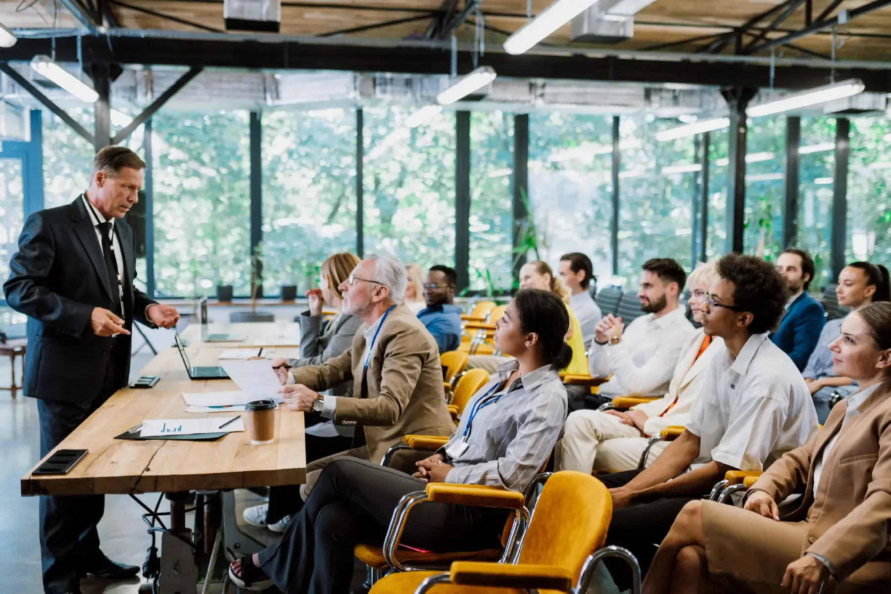 A business leader presenting to a diverse team during a strategic planning session, representing the impact of clear messaging in expanding to new B2B markets
