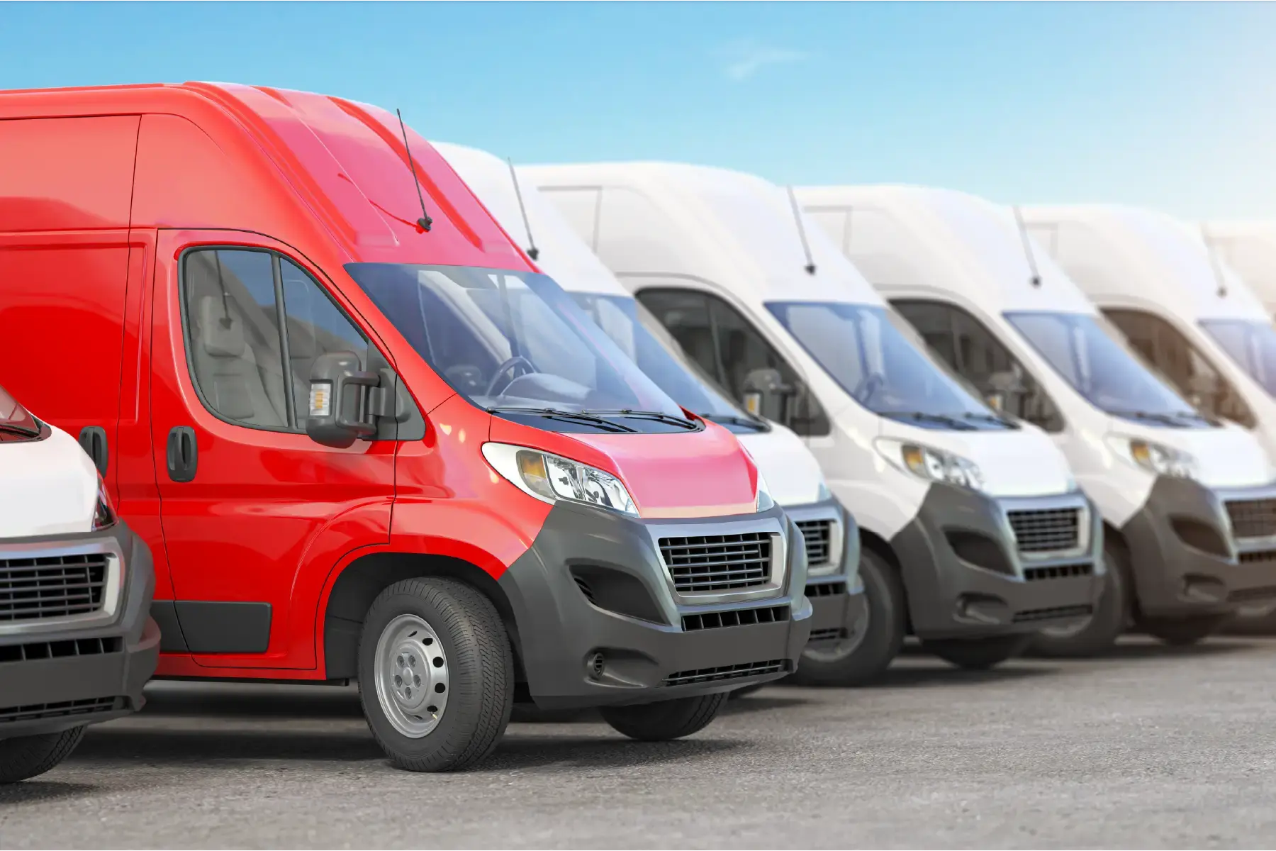 Fleet of commercial transit vans lined up for deployment, with one standout red van symbolising leadership and visibility in a global rollout
