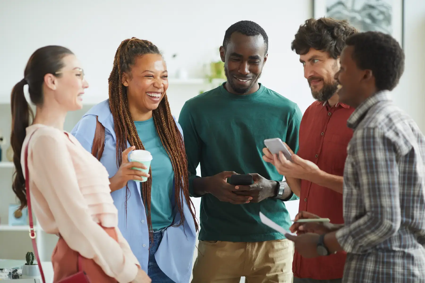 Diverse group of young professionals smiling and connecting during an inclusive youth campaign event, capturing the spirit of representation and authentic storytelling