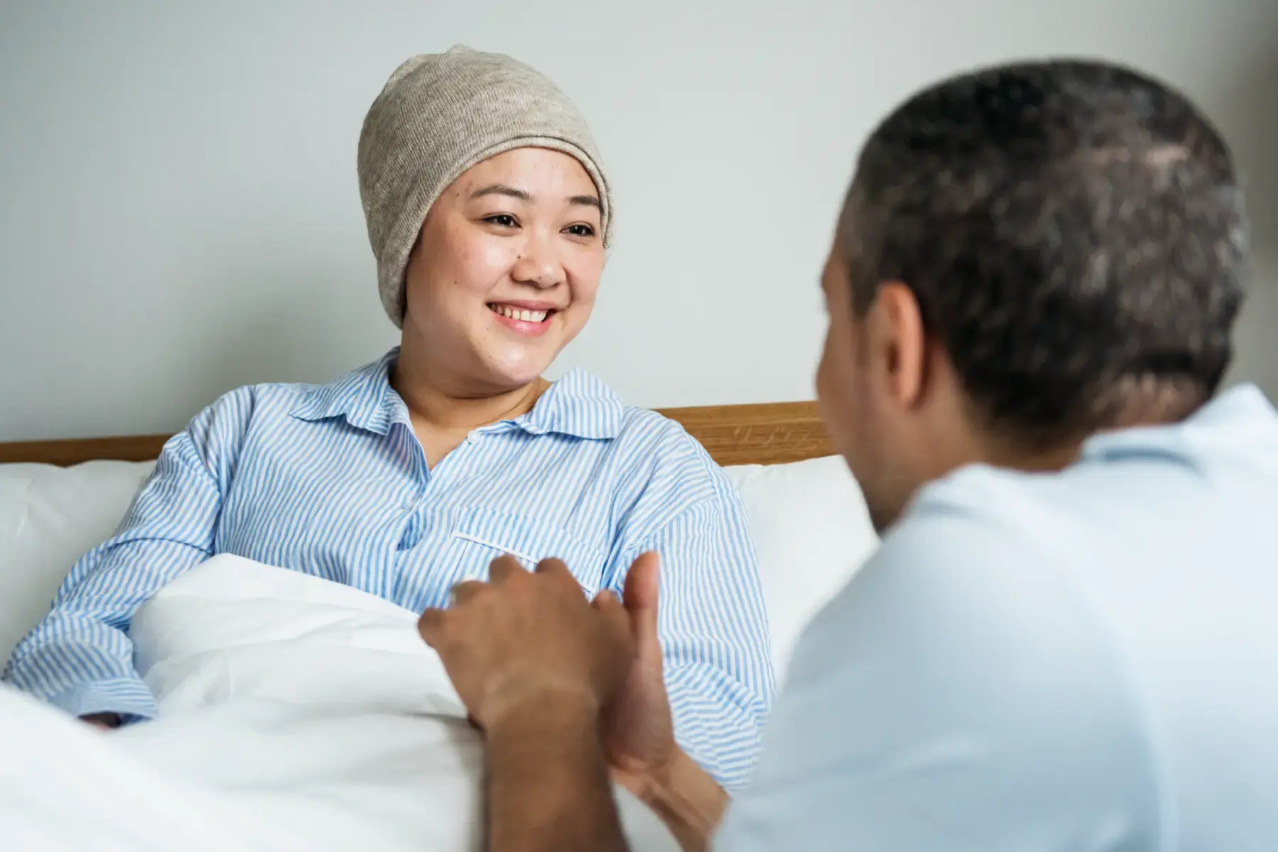 Smiling patient engaging in conversation with a carer, symbolising the human impact of medically validated wellness products in cancer recovery