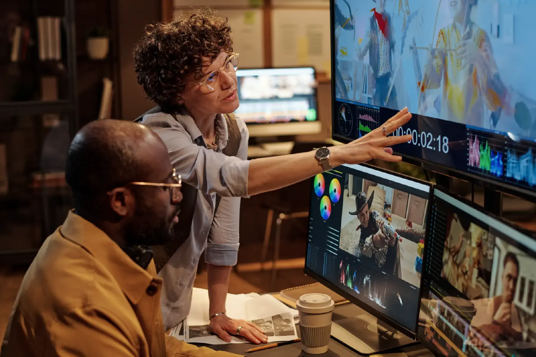 Creative team editing multimedia content across monitors, showcasing digital platform production environments