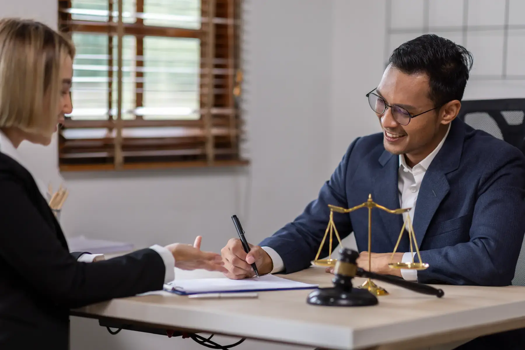 Lawyer consulting a client at a desk, symbolising trusted advisory and legal support