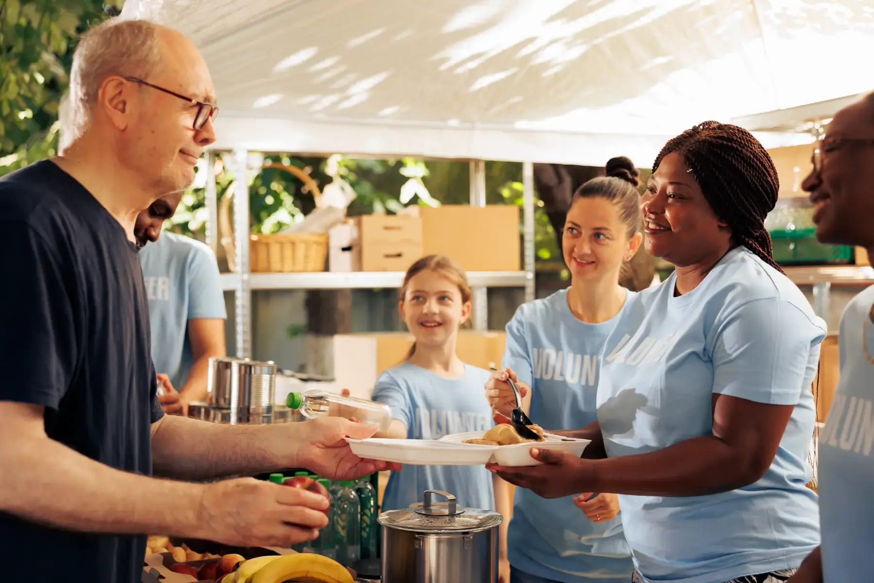 Volunteers serving food at a community outreach event, representing grassroots impact and nonprofit initiatives