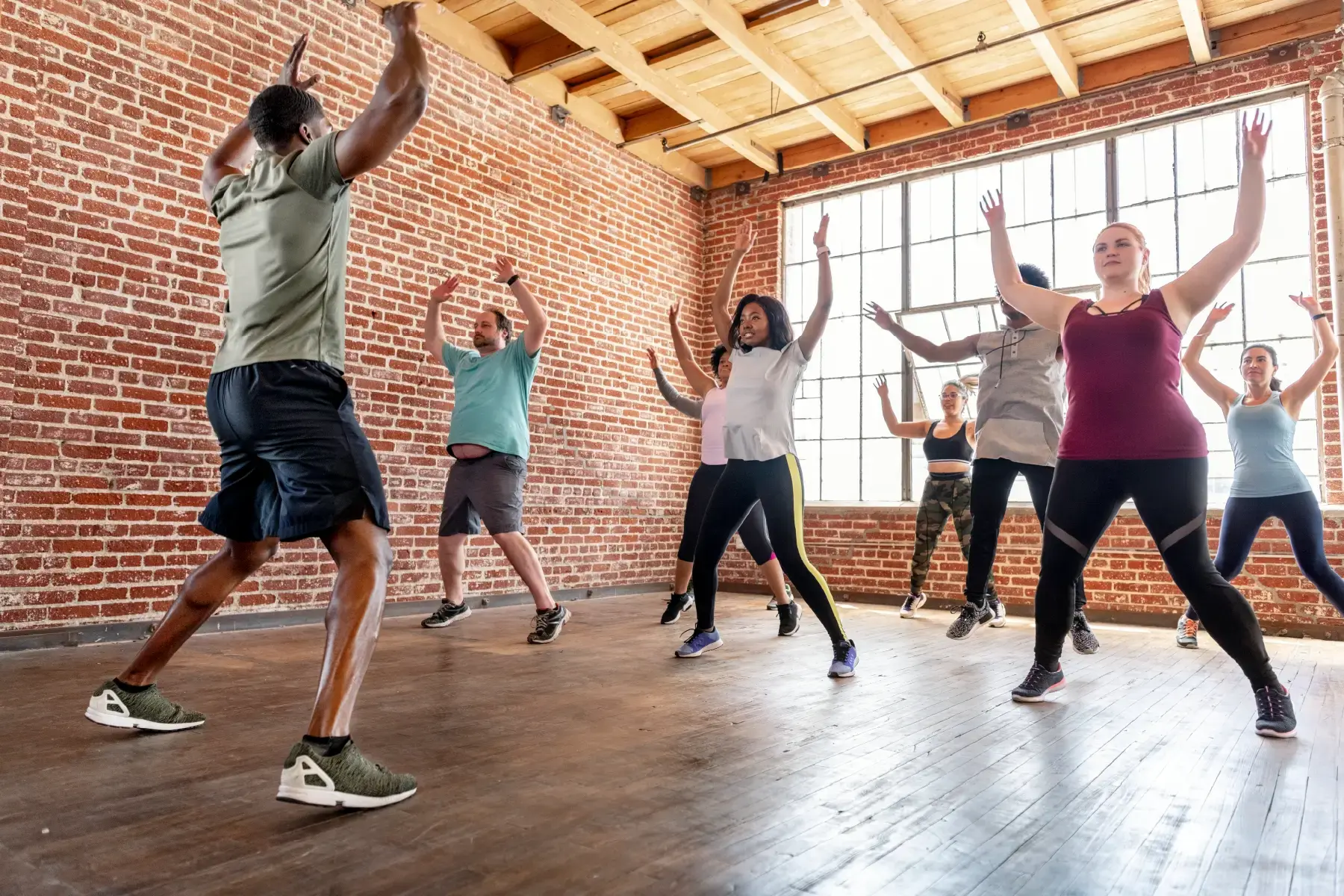 Group fitness session in a community centre with diverse participants promoting public wellbeing and active living