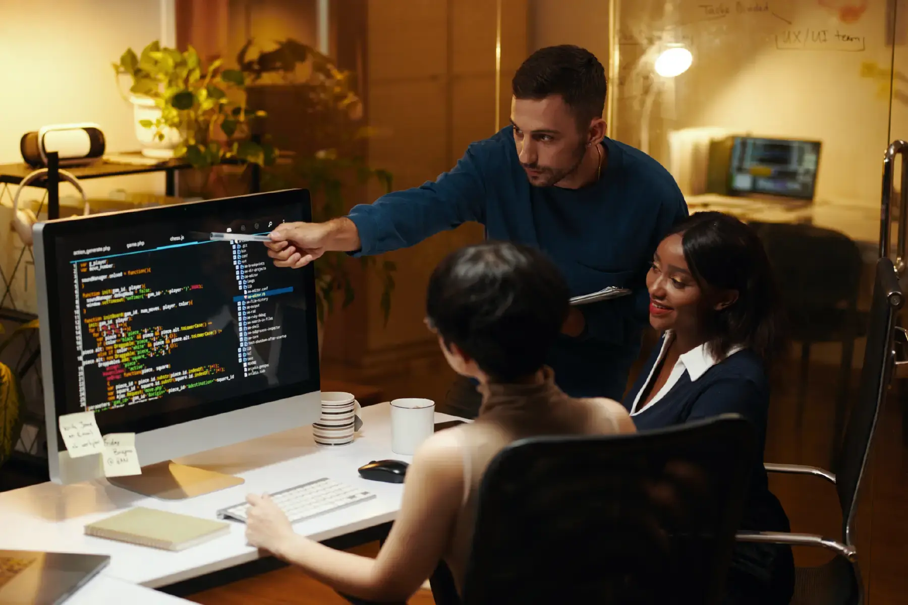 Team reviewing code on-screen in a collaborative workspace, reflecting the agile environment of SaaS product teams