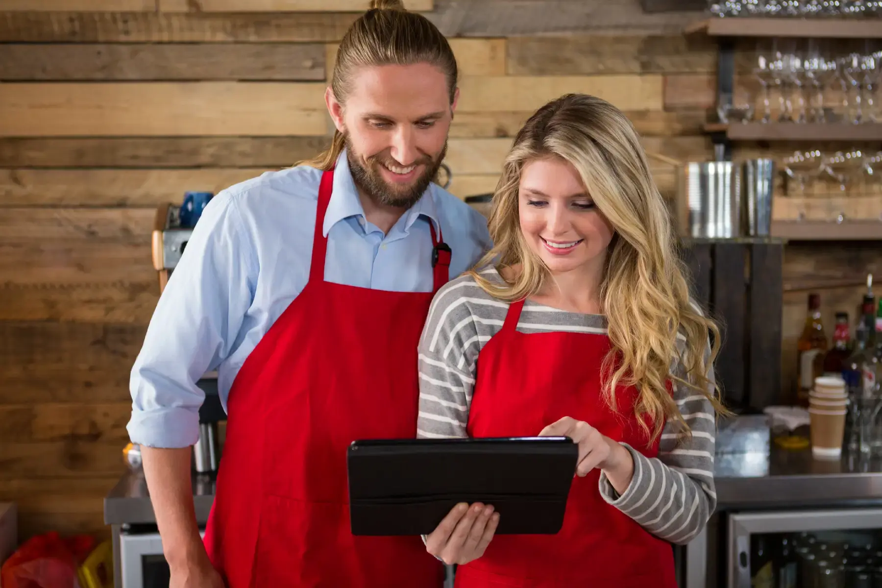 Small business owners using a tablet-based point-of-sale system, highlighting technology-enabled commerce in modern marketplaces