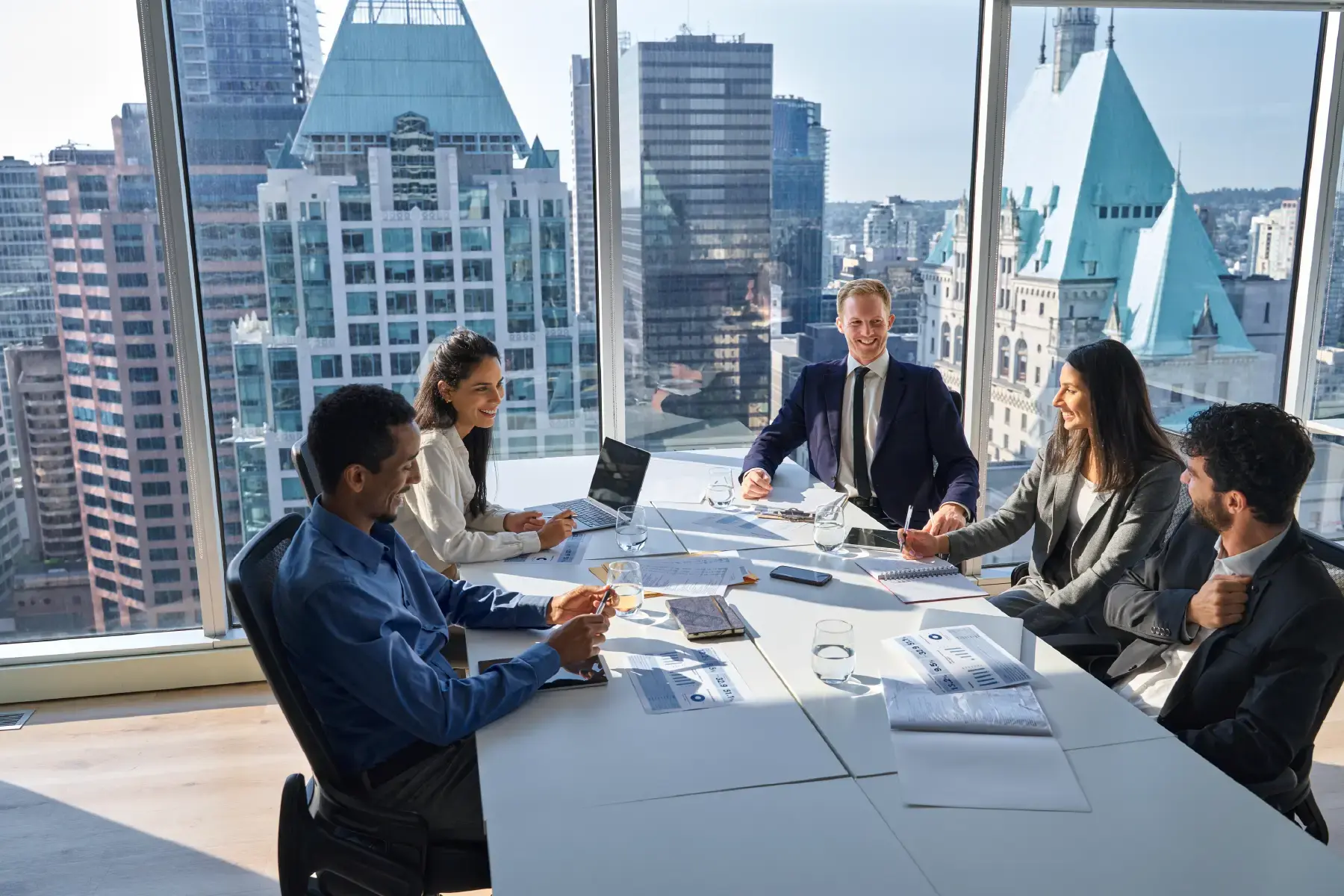 Diverse investment team meeting in a high-rise office, symbolising venture capital and private equity planning