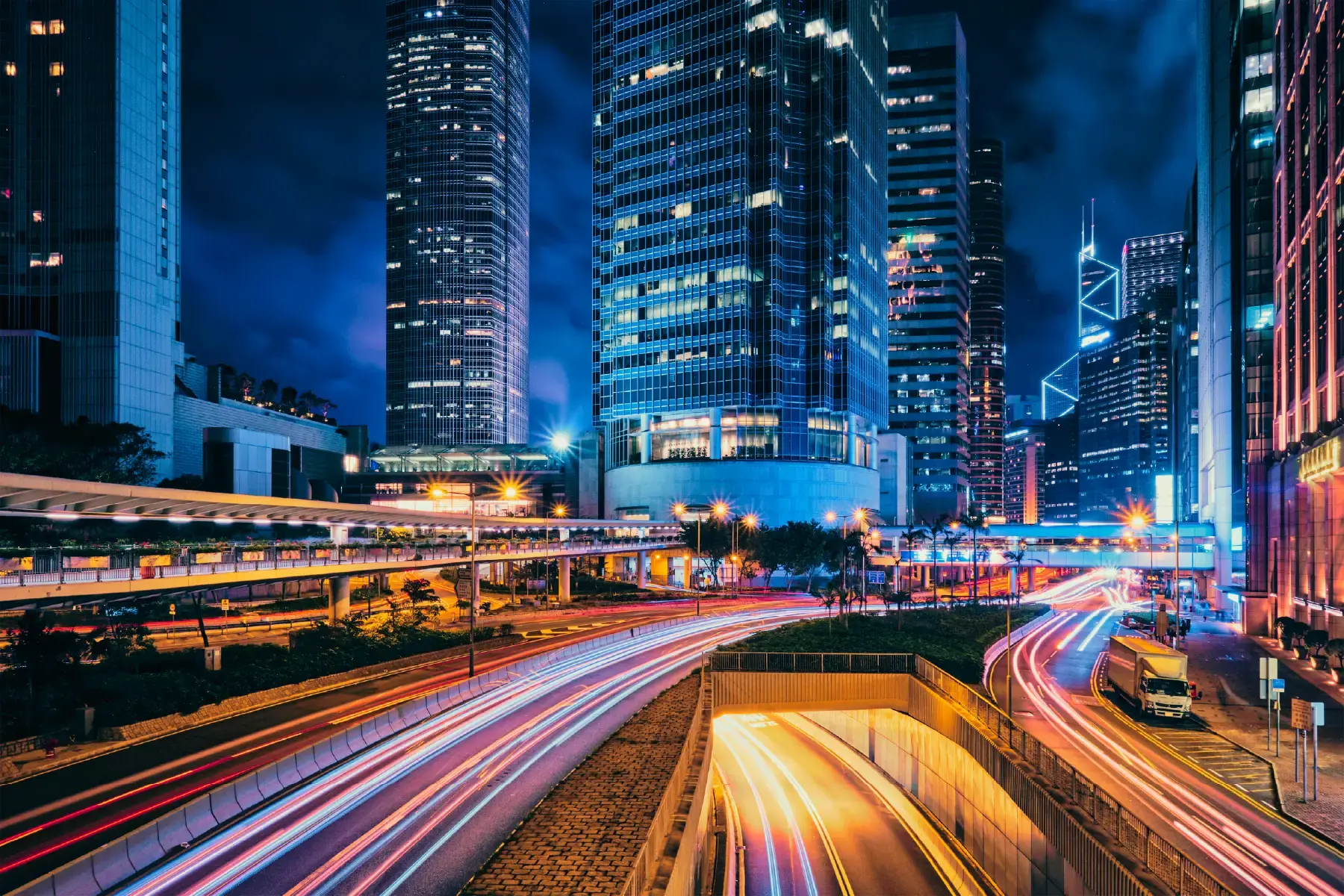 Futuristic city skyline at night with dynamic light trails, symbolising the pace and scale of digital transformation Futuristic city skyline at night with dynamic light trails, symbolising the pace and scale of digital transformation